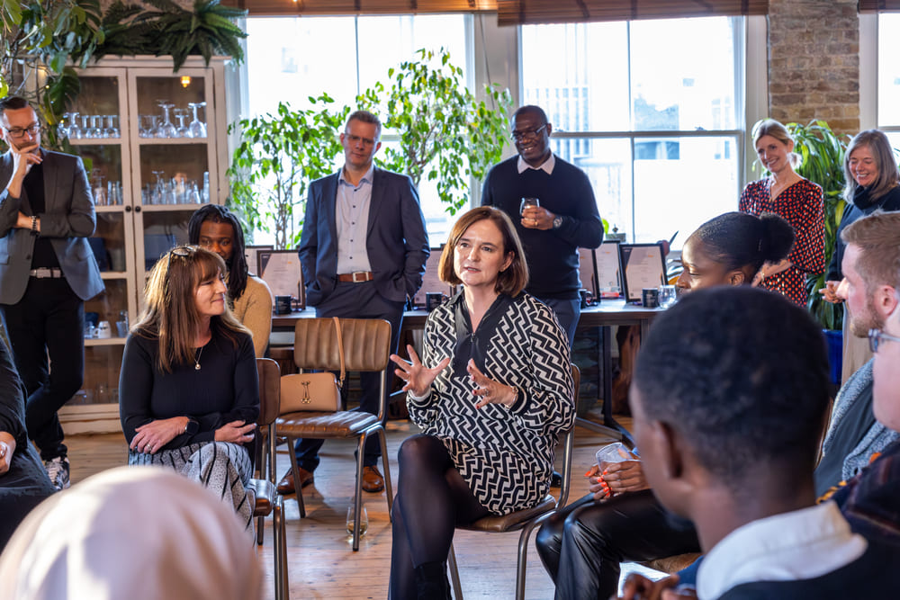 Hilary talking to a group, holding her hand forward whilst gesturing